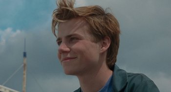 Movie still from “Summer of 85” (2020), directed by François Ozon – A young man with a spiky hair style; Close Up shot, Low angle