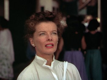 Movie still from “Summertime” (1955), directed by David Lean – An older woman in a white shirt is posing for a picture; Close Up shot, Low angle