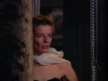 Movie still from “Summertime” (1955), directed by David Lean – A woman wearing a white scarf looking at the camera; Close Up shot, Low angle