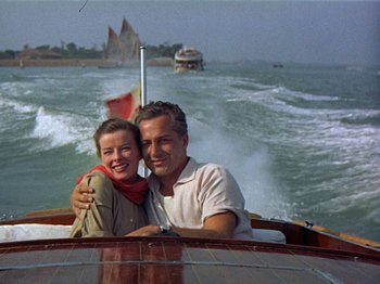 Movie still from “Summertime” (1955), directed by David Lean – A man and a woman sitting on a boat in the water; Medium shot, Low angle