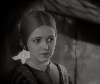 Movie still from “Sunrise” (1927), directed by F.W. Murnau – A young girl is looking into the camera; Close Up shot, High angle