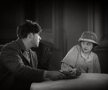 Movie still from “Sunrise” (1927), directed by F.W. Murnau – A man and a woman sitting at a table; Medium shot, High angle