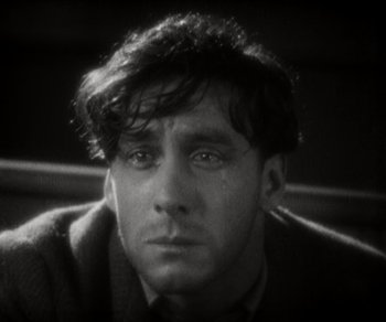 Movie still from “Sunrise” (1927), directed by F.W. Murnau – A black - and - white photo of a man crying; Close Up shot, High angle