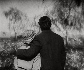 Movie still from “Sunrise” (1927), directed by F.W. Murnau – An older man and a younger woman standing next to each other; Medium shot, High angle