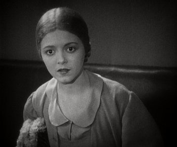 Movie still from “Sunrise” (1927), directed by F.W. Murnau – An old photo of a young girl with a teddy bear; Close Up shot, High angle