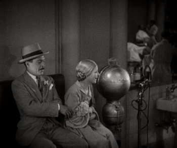 Movie still from “Sunrise” (1927), directed by F.W. Murnau – An old photo of a man and a woman sitting on a bench; Medium shot, High angle