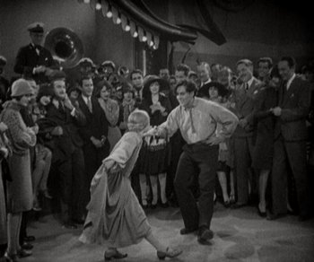 Movie still from “Sunrise” (1927), directed by F.W. Murnau – An old photo of a man and a woman dancing in front of a crowd; Wide shot, High angle