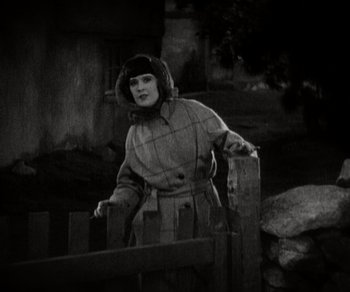 Movie still from “Sunrise” (1927), directed by F.W. Murnau – A woman standing next to a wooden fence; Medium shot, High angle