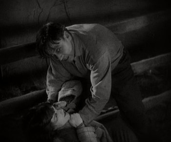 Movie still from “Sunrise” (1927), directed by F.W. Murnau – A man and a woman are fighting in a dark room; Medium shot, High angle