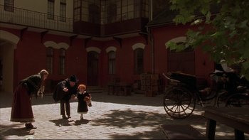 Movie still from “Sunshine” (1999), directed by István Szabó – An older woman and a young girl in front of an old carriage; Wide shot, High angle