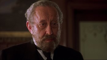 Movie still from “Sunshine” (1999), directed by István Szabó – An older man with a beard and a mustache; Close Up shot, Over the shoulder angle