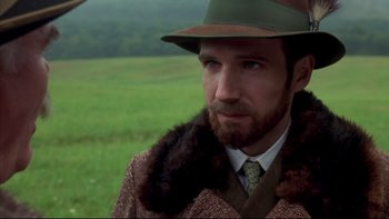 Movie still from “Sunshine” (1999), directed by István Szabó – A man with a beard wearing a hat and a coat; Close Up shot, Over the shoulder angle