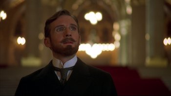 Movie still from “Sunshine” (1999), directed by István Szabó – A man in a suit and tie looking up at the ceiling; Close Up shot, Low angle