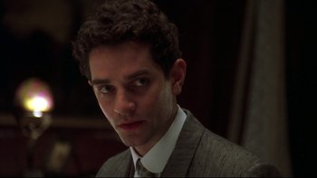 Movie still from “Sunshine” (1999), directed by István Szabó – A person wearing a suit and tie; Close Up shot, Low angle