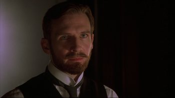 Movie still from “Sunshine” (1999), directed by István Szabó – A person wearing a suit and tie; Close Up shot, Low angle