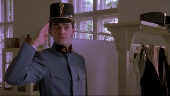 Movie still from “Sunshine” (1999), directed by István Szabó – A man in uniform saluting in front of a window; Close Up shot, Low angle