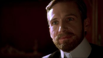 Movie still from “Sunshine” (1999), directed by István Szabó – A person wearing a suit and tie; Close Up shot, Low angle
