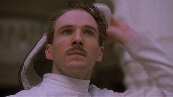 Movie still from “Sunshine” (1999), directed by István Szabó – A person holding a hair brush; Close Up shot, Low angle