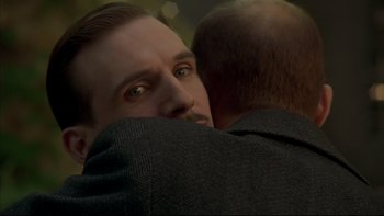 Movie still from “Sunshine” (1999), directed by István Szabó – A person hugging another person; Close Up shot, Over the shoulder angle