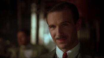 Movie still from “Sunshine” (1999), directed by István Szabó – A person wearing a suit and tie; Close Up shot, Low angle