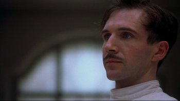 Movie still from “Sunshine” (1999), directed by István Szabó – A person wearing a white shirt; Close Up shot, Low angle