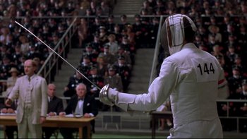 Movie still from “Sunshine” (1999), directed by István Szabó – A fencer in a white suit is holding a sword; Medium shot, Low angle
