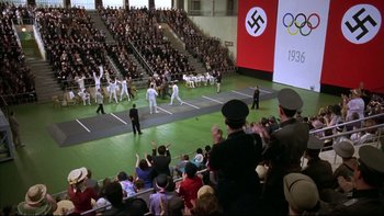 Movie still from “Sunshine” (1999), directed by István Szabó – A crowd of people in a stadium watching an event; Extreme Wide shot, High angle