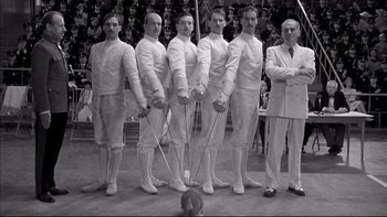 Movie still from “Sunshine” (1999), directed by István Szabó – A black and white photo of a group of fencers; Medium shot, Low angle