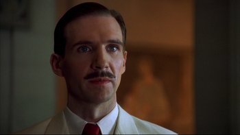 Movie still from “Sunshine” (1999), directed by István Szabó – A person wearing a suit and a tie; Close Up shot, Low angle