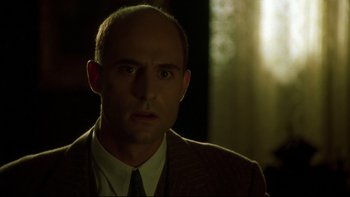 Movie still from “Sunshine” (1999), directed by István Szabó – A man in a suit and tie looking at the camera; Close Up shot, Low angle