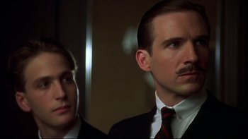 Movie still from “Sunshine” (1999), directed by István Szabó – A man in a suit and tie next to another man in a suit and tie; Close Up shot, Low angle