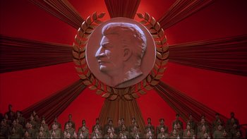 Movie still from “Sunshine” (1999), directed by István Szabó – A red room with a large statue of a man's head on the wall; Extreme Wide shot, High angle