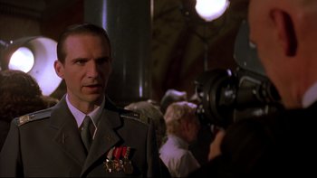 Movie still from “Sunshine” (1999), directed by István Szabó – A man in a military uniform standing in front of a camera; Close Up shot, Over the shoulder angle