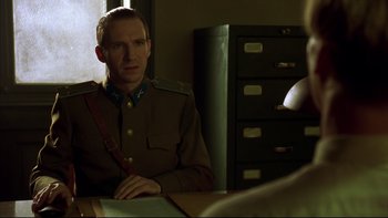 Movie still from “Sunshine” (1999), directed by István Szabó – A man in a uniform sitting at a table; Medium shot, Over the shoulder angle