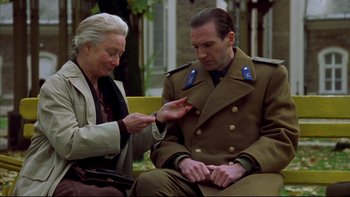 Movie still from “Sunshine” (1999), directed by István Szabó – An older woman and a man sitting on a bench; Medium shot, Low angle