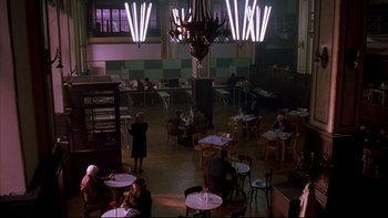 Movie still from “Sunshine” (1999), directed by István Szabó – People are sitting at tables in a large room; Extreme Wide shot, High angle