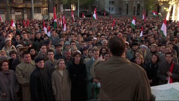 Movie still from “Sunshine” (1999), directed by István Szabó – A large group of people standing in front of a building; Wide shot, High angle