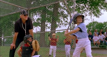 Movie still from “Super Troopers” (2001), directed by Jay Chandrasekhar – A group of young boys playing baseball on a field; Medium shot, Over the shoulder angle