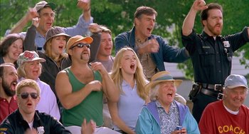 Movie still from “Super Troopers” (2001), directed by Jay Chandrasekhar – A group of people sitting on a bench and laughing; Medium shot, Low angle
