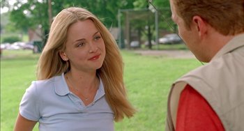 Movie still from “Super Troopers” (2001), directed by Jay Chandrasekhar – A young woman talking to a young man in a park; Close Up shot, Over the shoulder angle