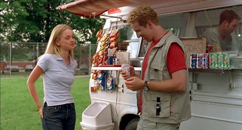 Movie still from “Super Troopers” (2001), directed by Jay Chandrasekhar – A man and a woman standing in front of a food truck; Medium shot, Over the shoulder angle
