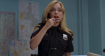 Movie still from “Super Troopers” (2001), directed by Jay Chandrasekhar – A police officer talking on the phone while holding a cell phone; Close Up shot, Low angle