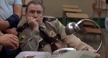 Movie still from “Super Troopers” (2001), directed by Jay Chandrasekhar – A police officer sitting in front of a computer; Close Up shot, High angle