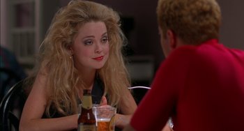 Movie still from “Super Troopers” (2001), directed by Jay Chandrasekhar – A woman sitting at a table with a man in a red shirt; Close Up shot, Over the shoulder angle