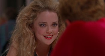 Movie still from “Super Troopers” (2001), directed by Jay Chandrasekhar – A young woman smiles brightly as she talks to another woman; Close Up shot, Over the shoulder angle