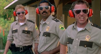 Movie still from “Super Troopers” (2001), directed by Jay Chandrasekhar – A group of men wearing ear muffs and sunglasses; Medium shot, Low angle