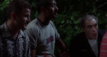 A group of men standing next to each other in a forest