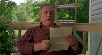 Movie still from “Super Troopers” (2001), directed by Jay Chandrasekhar – A man sitting on a porch reading a letter; Close Up shot, Low angle