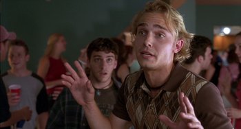 Movie still from “Super Troopers” (2001), directed by Jay Chandrasekhar – Two young men standing next to each other in front of a wall; Close Up shot, Low angle