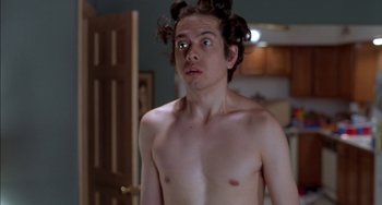 Movie still from “Super Troopers” (2001), directed by Jay Chandrasekhar – A shirtless man with curlers on his head; Medium shot, Low angle